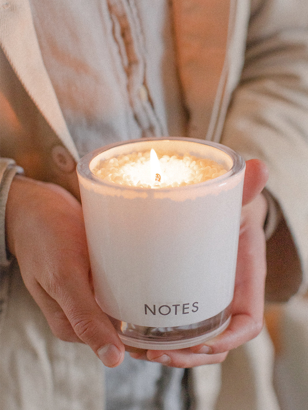 Lit NOTES® Candle Refill in hand