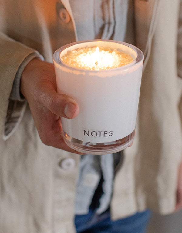 NOTES® Candle Refill being held in one hand